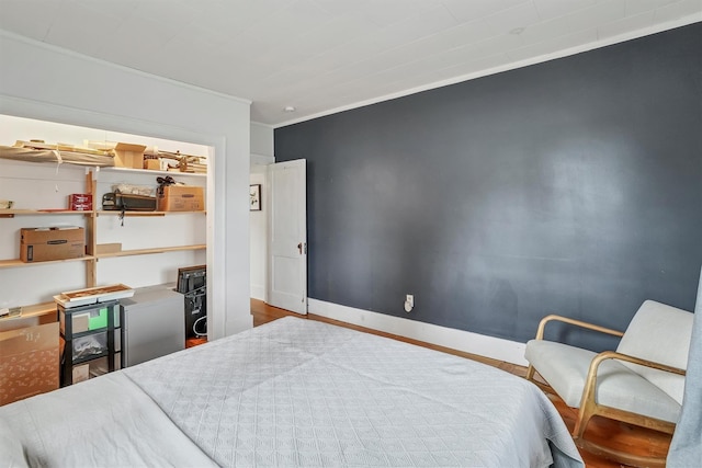 bedroom with hardwood / wood-style floors and crown molding