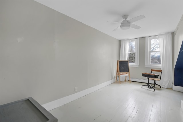 living area featuring ceiling fan and a baseboard radiator