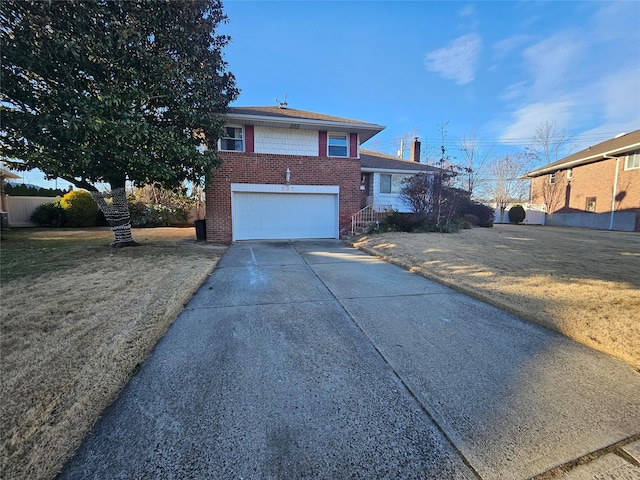 split level home featuring a garage and a front lawn