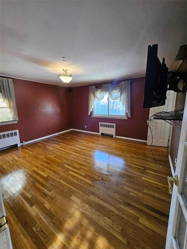 interior space featuring wood-type flooring and radiator