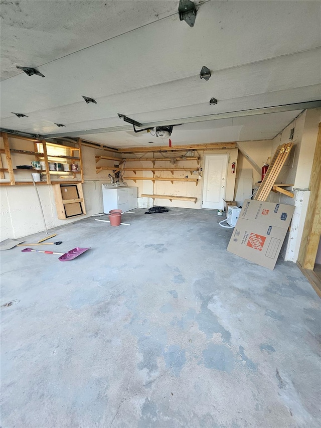 garage featuring washing machine and clothes dryer and a garage door opener