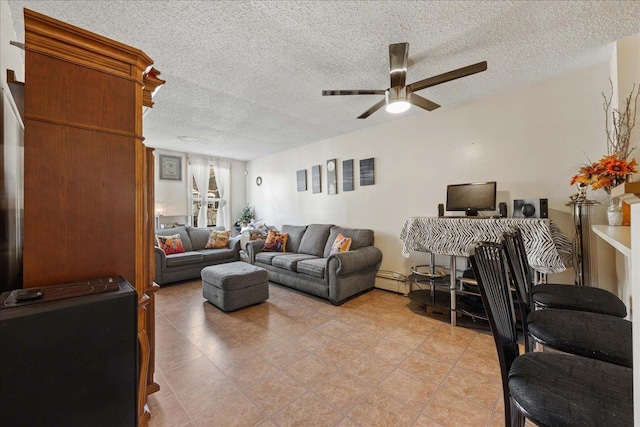 living room featuring ceiling fan and a textured ceiling