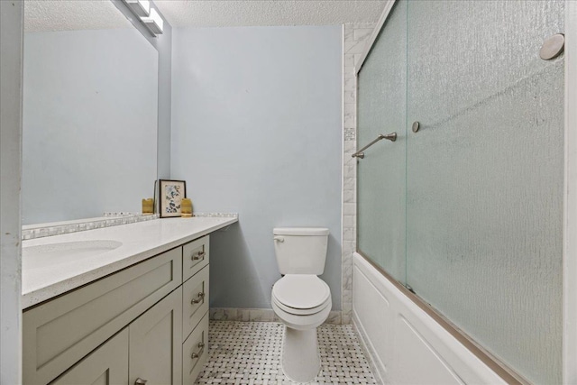 full bathroom with vanity, bath / shower combo with glass door, a textured ceiling, and toilet