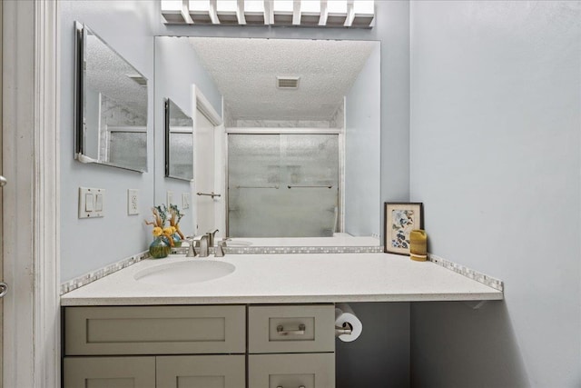 bathroom featuring vanity and a textured ceiling