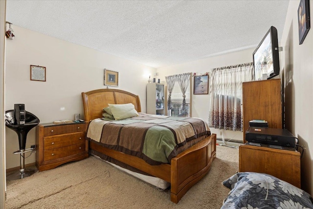 bedroom featuring light carpet and a textured ceiling