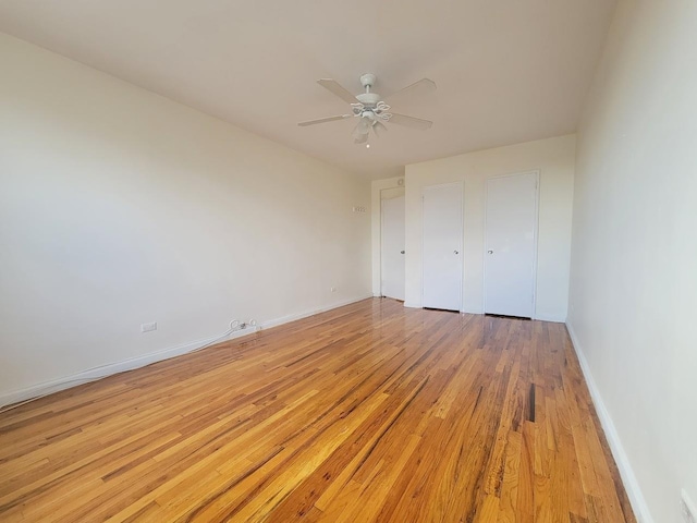 unfurnished bedroom with ceiling fan and light wood-type flooring