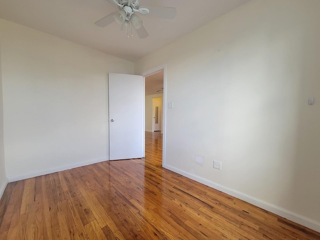 spare room featuring wood-type flooring and ceiling fan