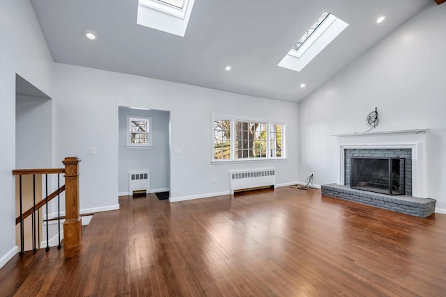 unfurnished living room with high vaulted ceiling, dark hardwood / wood-style floors, radiator, and a fireplace