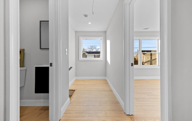 hallway with light hardwood / wood-style flooring