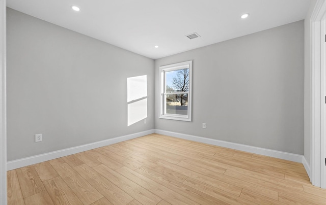 empty room with light hardwood / wood-style flooring