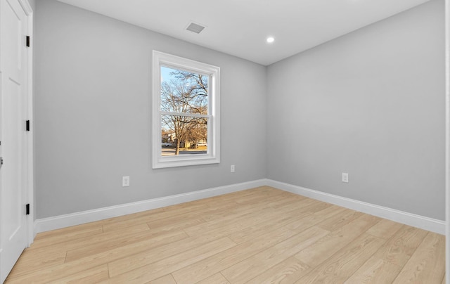 spare room with light hardwood / wood-style flooring