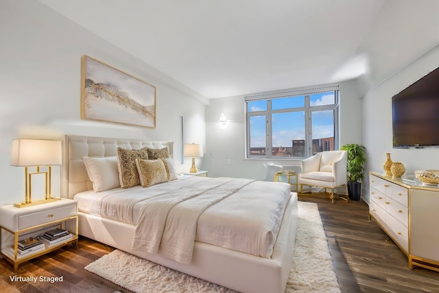 bedroom with dark wood-type flooring