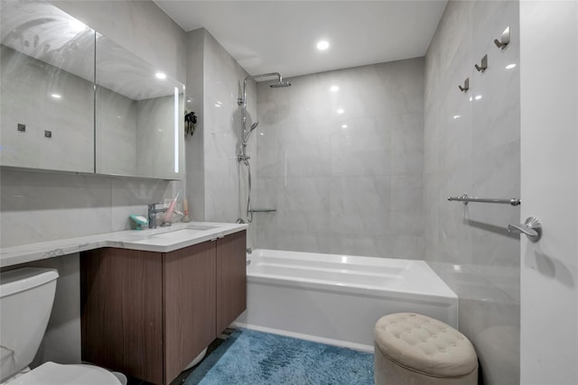 full bathroom featuring shower / bathtub combination, tile walls, toilet, and vanity