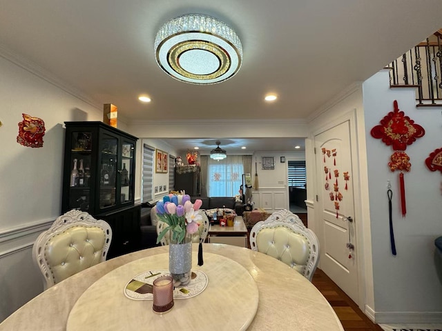 dining space featuring dark hardwood / wood-style flooring and crown molding