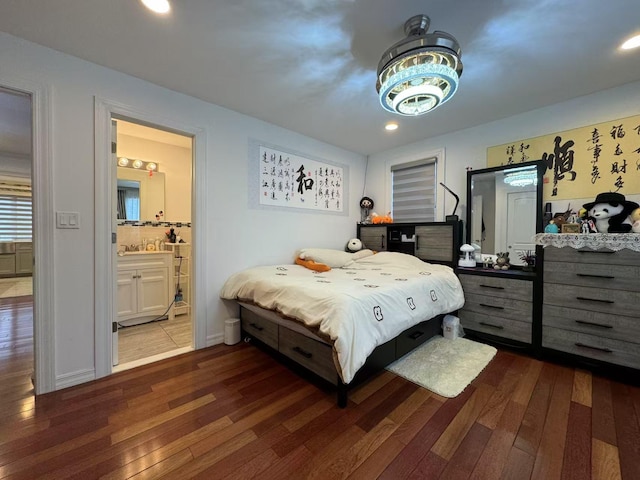 bedroom featuring dark hardwood / wood-style flooring and ensuite bathroom