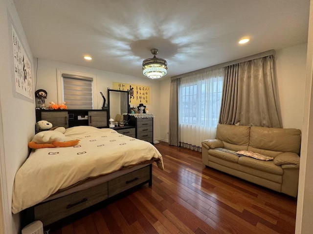 bedroom with dark hardwood / wood-style flooring