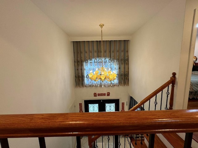 stairs featuring a towering ceiling and an inviting chandelier