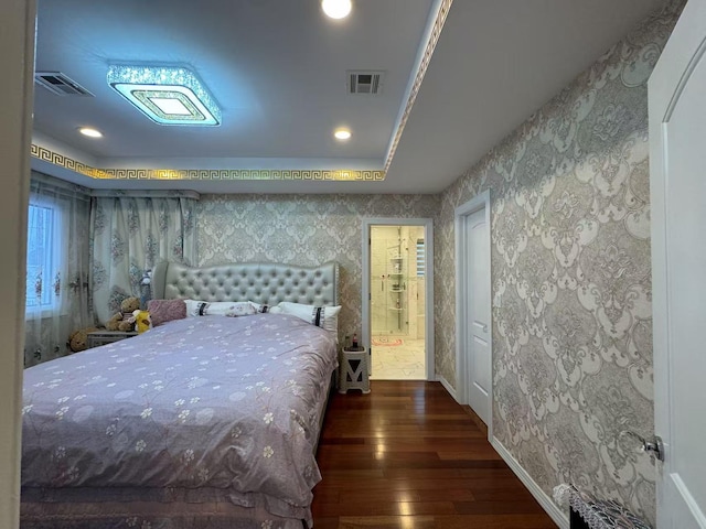 bedroom with dark wood-type flooring and a tray ceiling