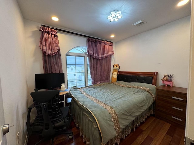 bedroom with dark hardwood / wood-style flooring