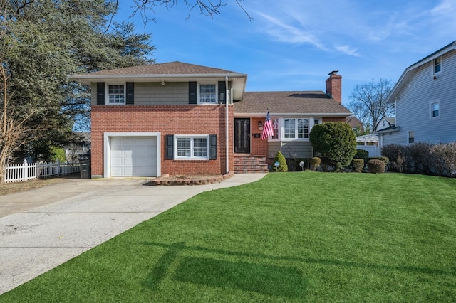 split level home with a garage and a front yard