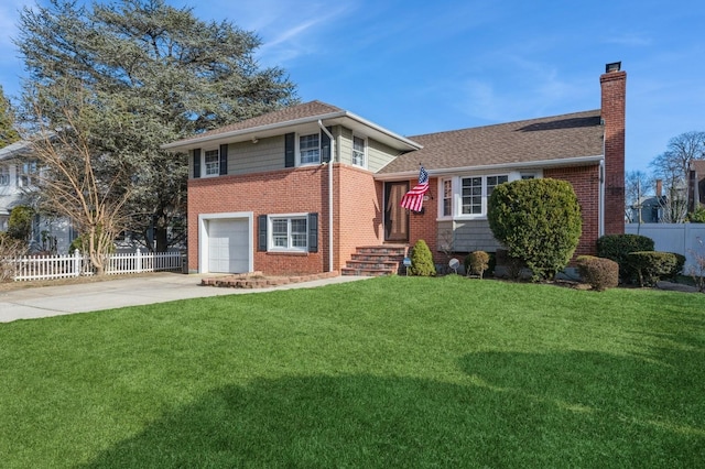 split level home with a garage and a front lawn