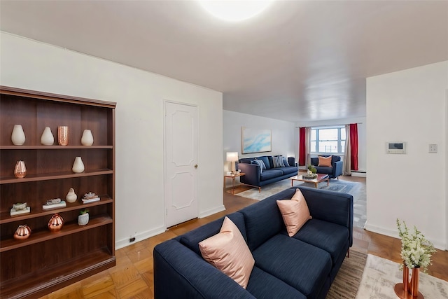 living room featuring light parquet flooring and a baseboard heating unit