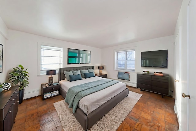 bedroom featuring dark parquet flooring and a baseboard radiator