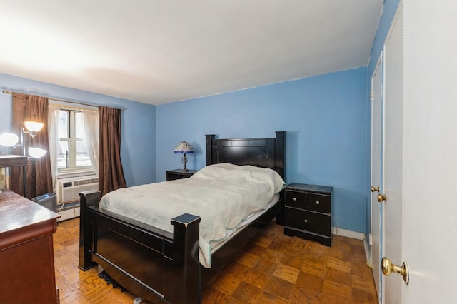 bedroom with dark parquet flooring and a baseboard radiator