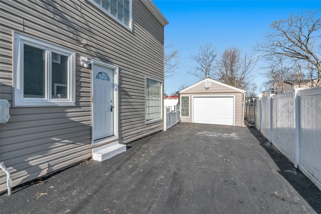 exterior space featuring a garage and an outbuilding