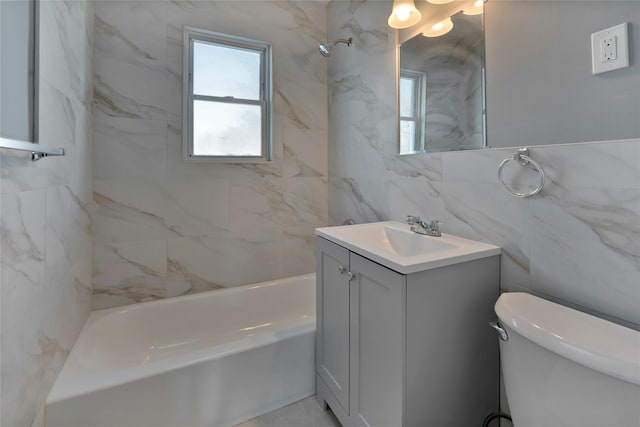 full bathroom featuring vanity, tiled shower / bath combo, tile walls, and toilet