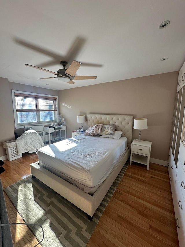 bedroom featuring ceiling fan and dark hardwood / wood-style floors