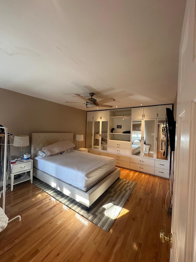 bedroom featuring wood-type flooring and ceiling fan