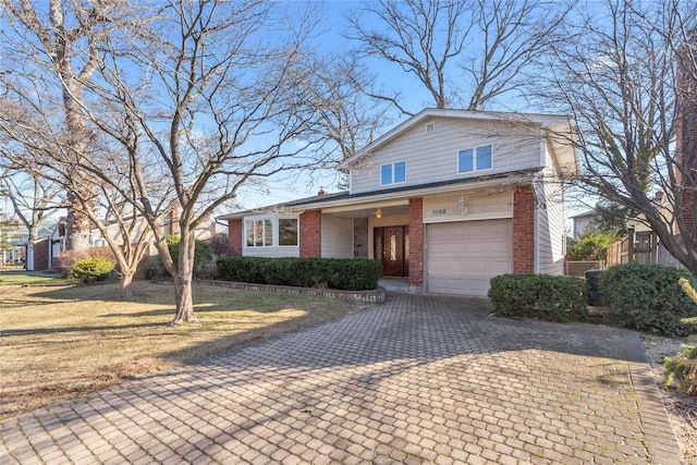 view of front of house featuring a front yard and a garage