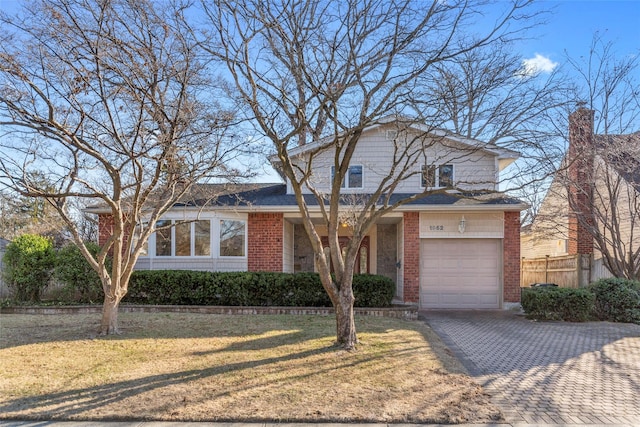 view of front of property with a front yard and a garage