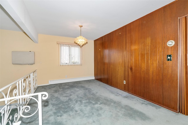 unfurnished room featuring carpet, wood walls, a notable chandelier, a baseboard heating unit, and beam ceiling