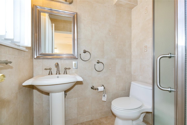 bathroom featuring toilet, decorative backsplash, and tile walls