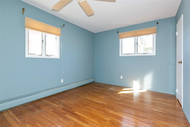 unfurnished room with ceiling fan, a baseboard radiator, and light hardwood / wood-style floors