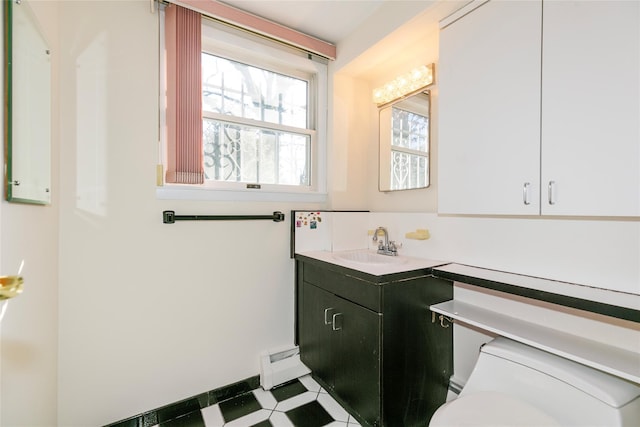 bathroom featuring a baseboard radiator, vanity, and toilet