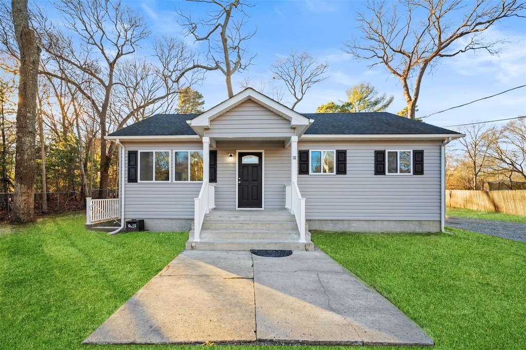 bungalow-style home with a front yard