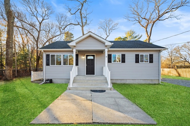 bungalow-style home with a front yard