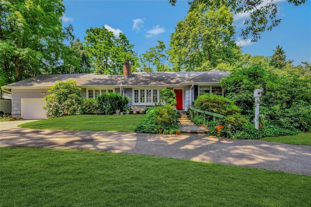 ranch-style house with a garage and a front yard