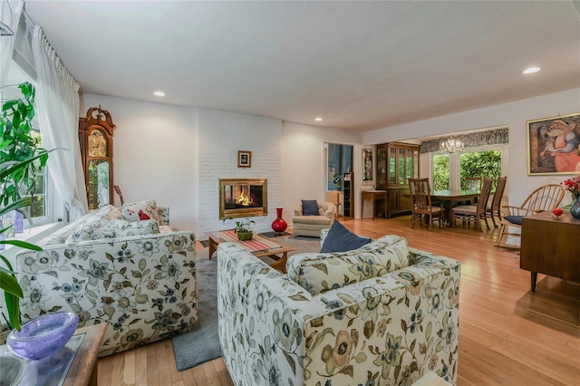 living room with a fireplace and light hardwood / wood-style flooring