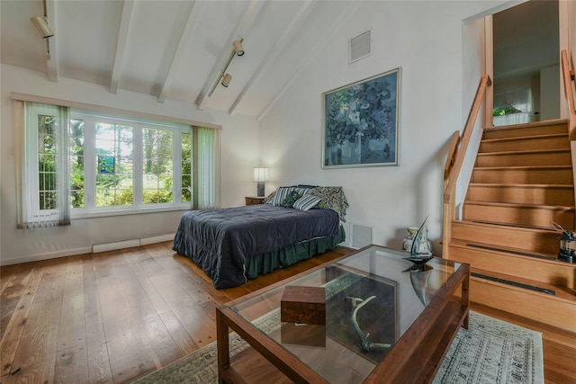 bedroom with beamed ceiling, wood-type flooring, and high vaulted ceiling