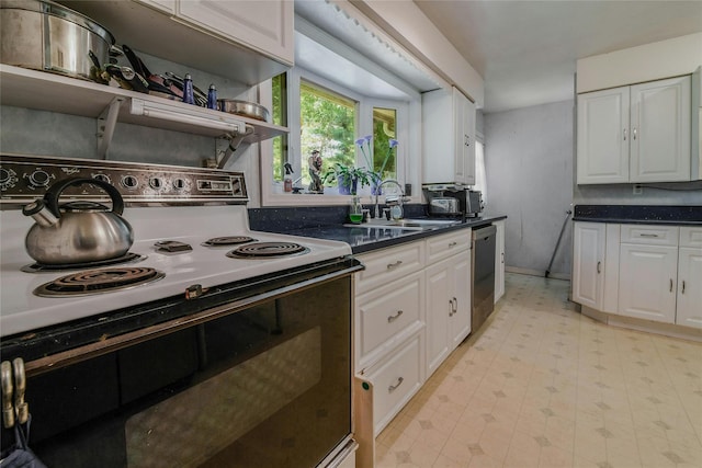 kitchen featuring electric range, white cabinetry, stainless steel dishwasher, and sink