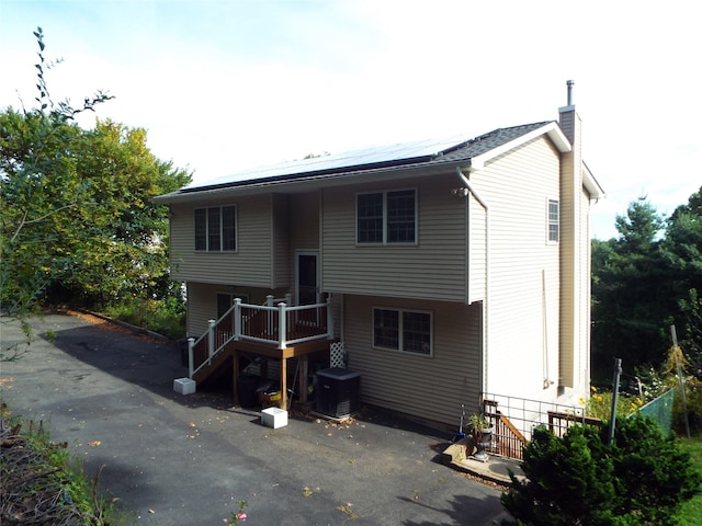 rear view of property featuring central air condition unit