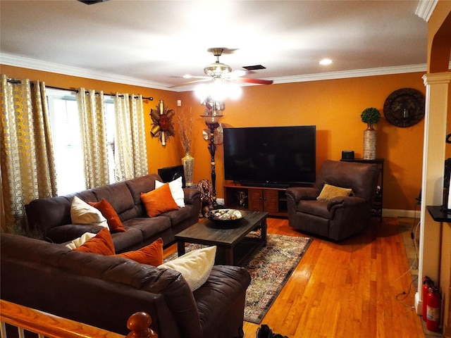 living room with crown molding, ceiling fan, decorative columns, and hardwood / wood-style flooring