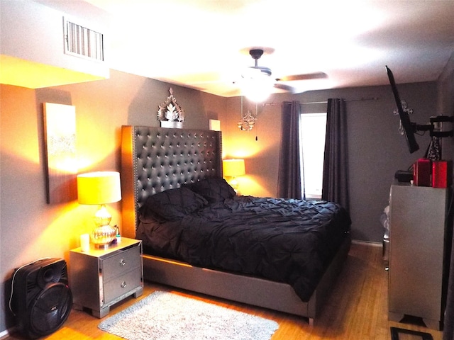 bedroom with ceiling fan and light wood-type flooring