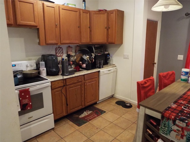 kitchen with light tile patterned floors and white appliances