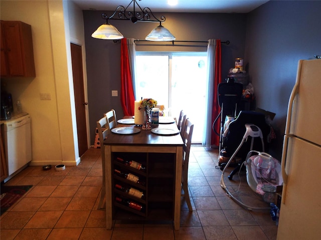 dining area with dark tile patterned floors