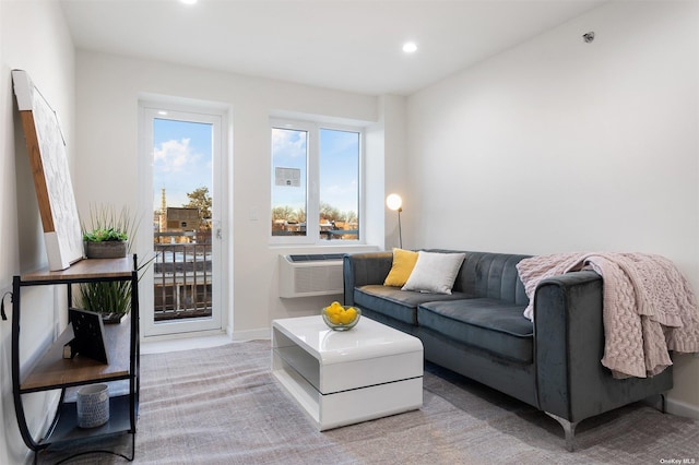 carpeted living room with a wall unit AC